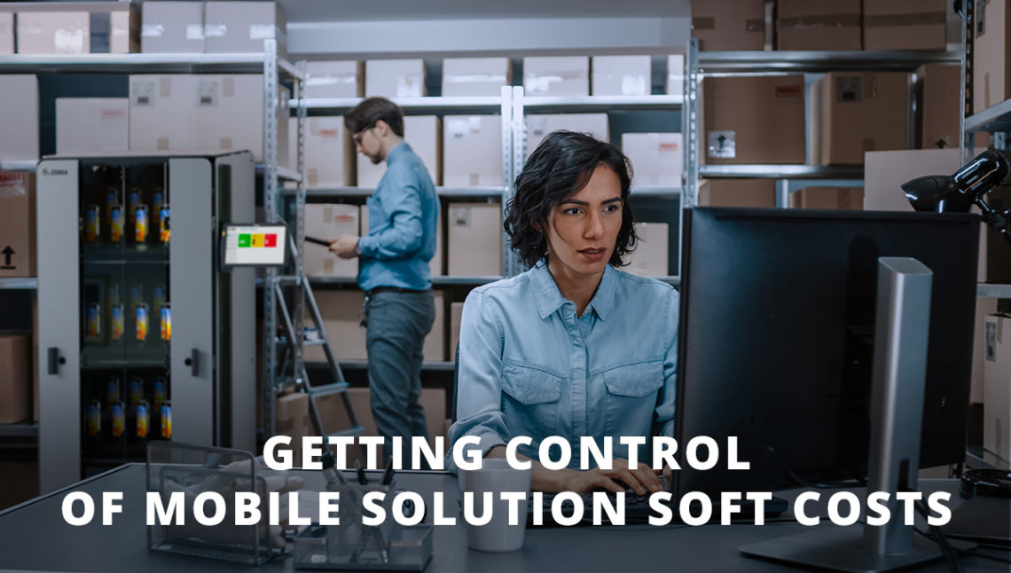 Woman working at computer while man in background images docking cabinet of mobile computers