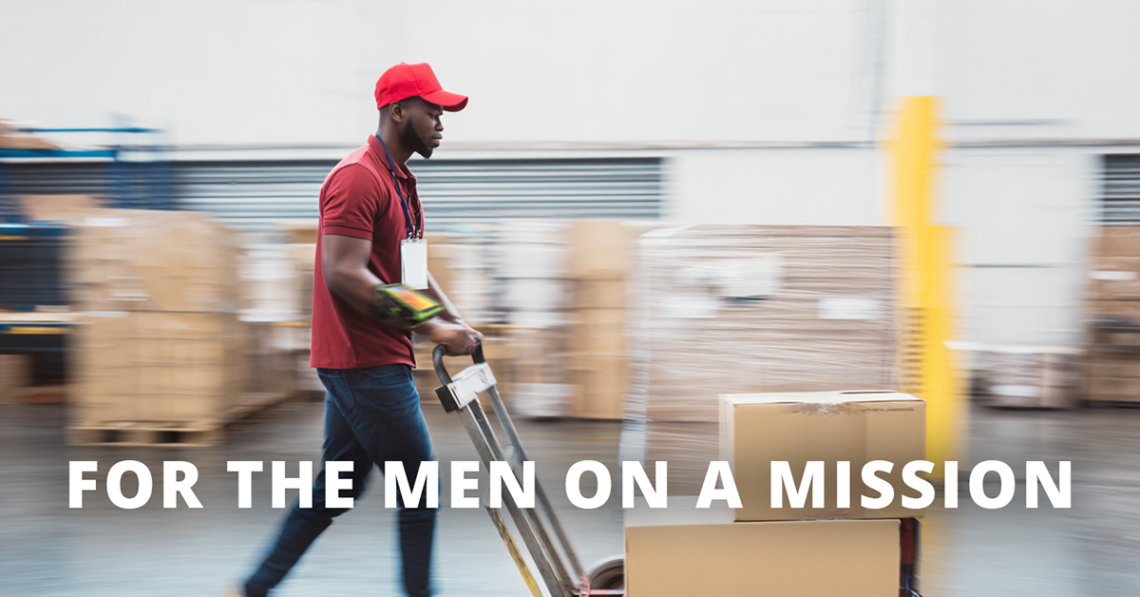 Warehouse worker walking swiftly through a warehouse to delivery packages on a dolly. He has a Zebra WT600 on his wrist. The overlay reads "for the men on a mission"